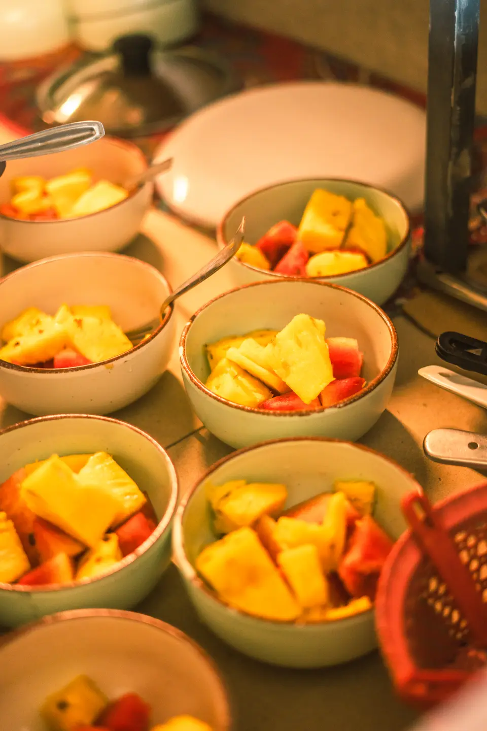 Bowls of cut fruit going out to the table