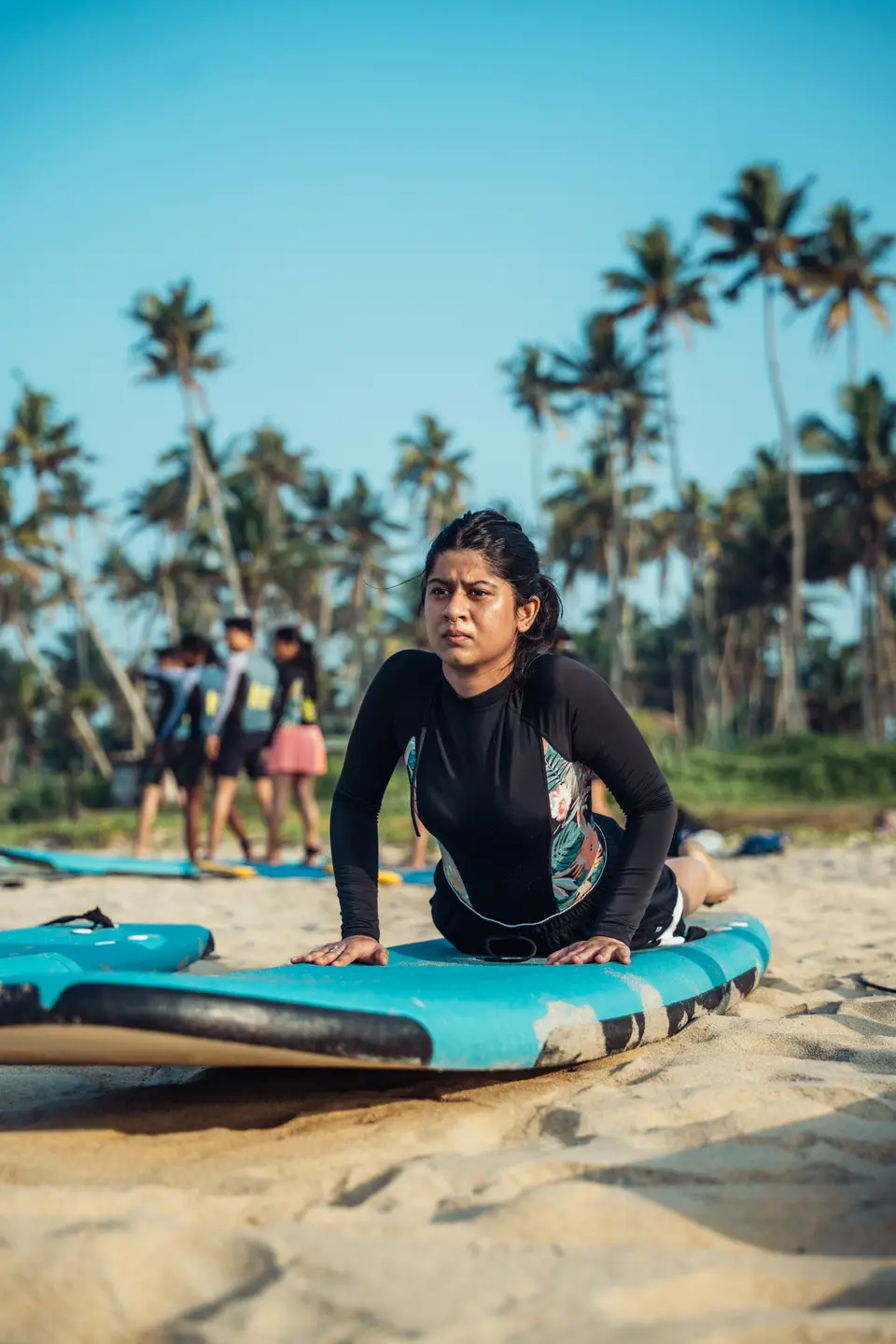 A group warming up on the sand before a surf session