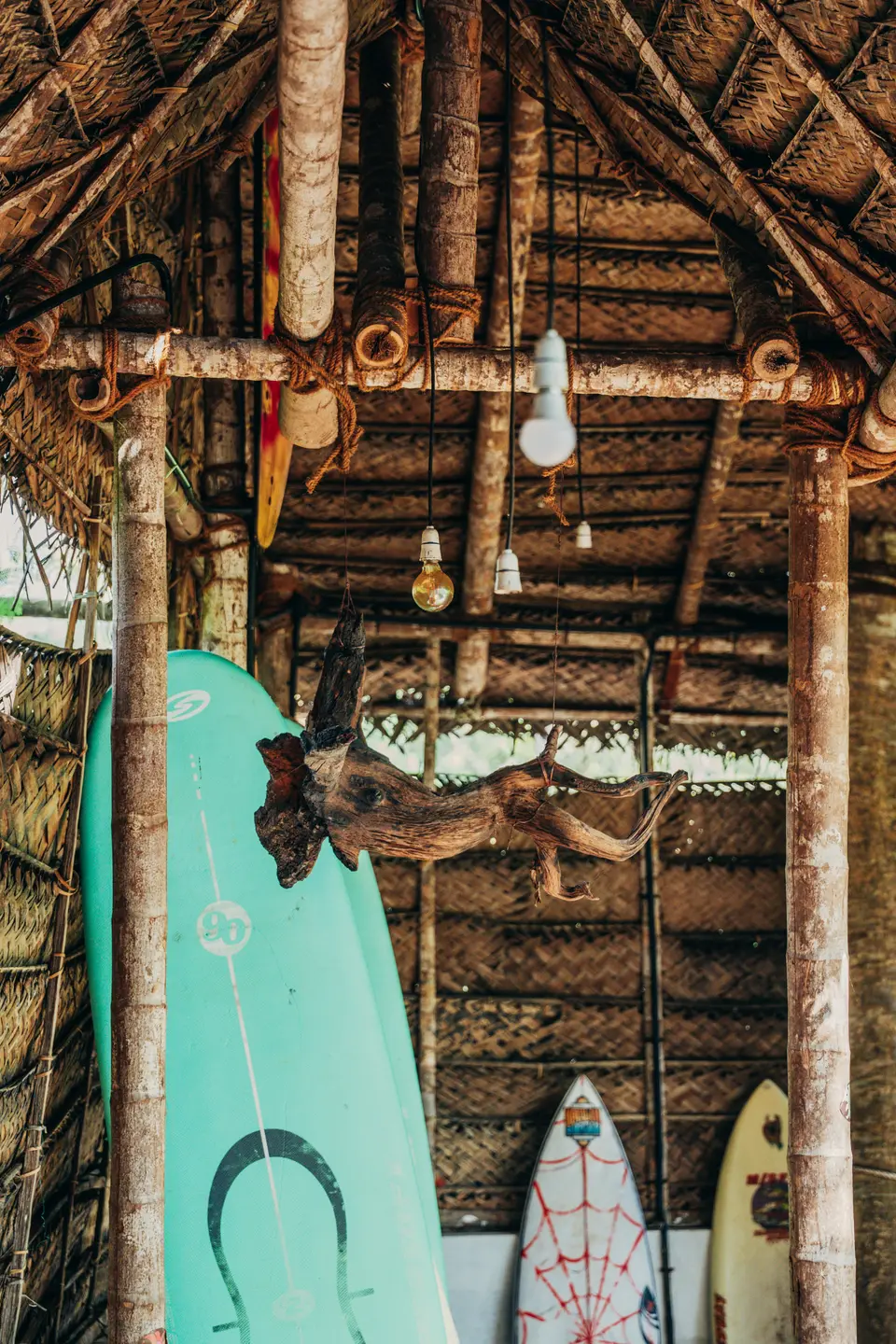 Board racks under the thatch at Kuma Surf