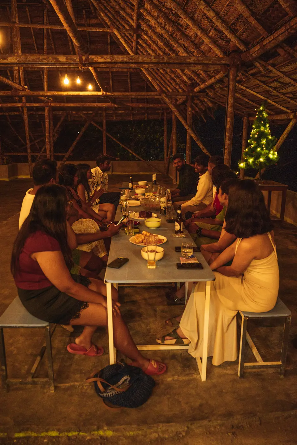 The rooftop at night, everyone still sitting