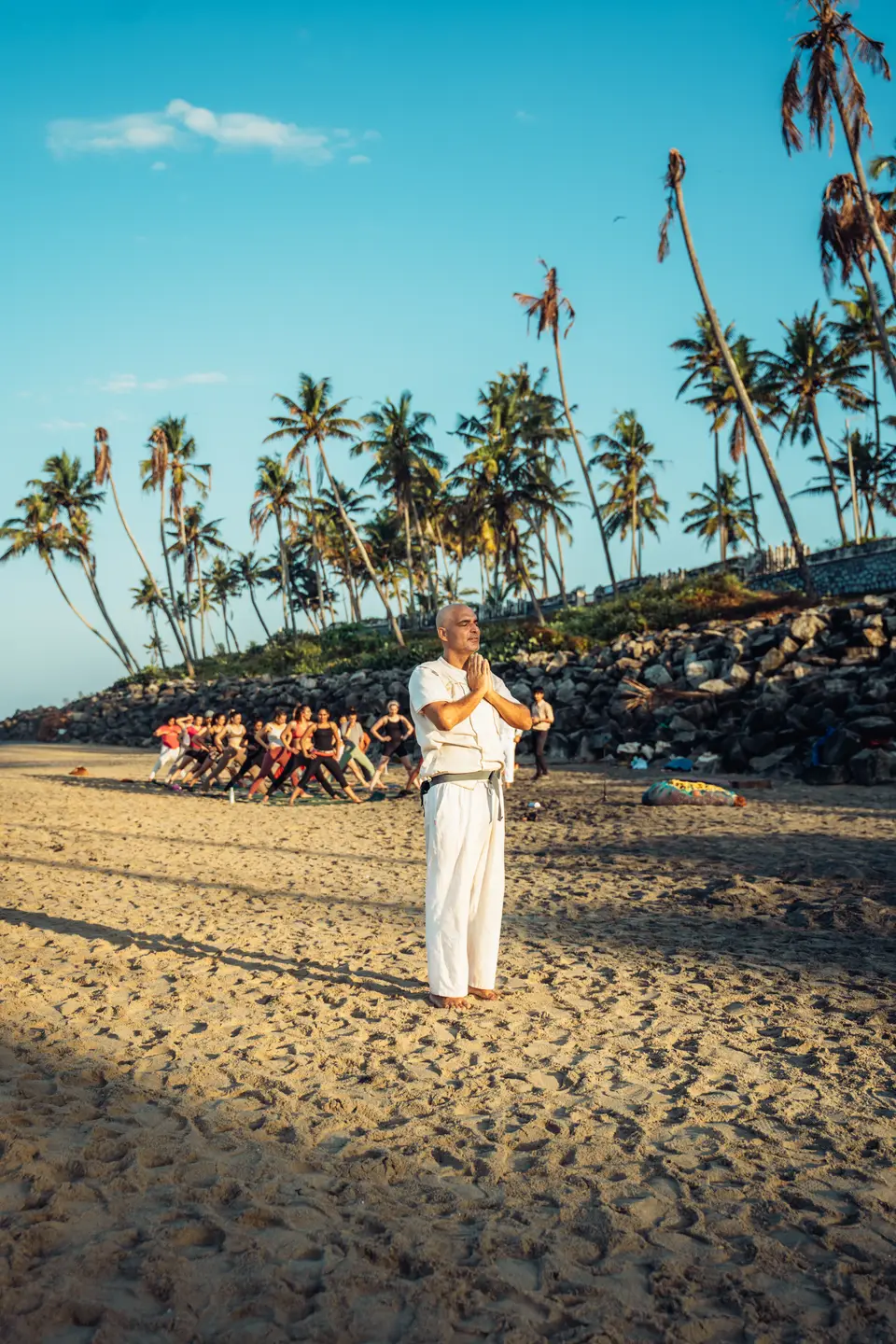 A group gathered on the sand at dusk