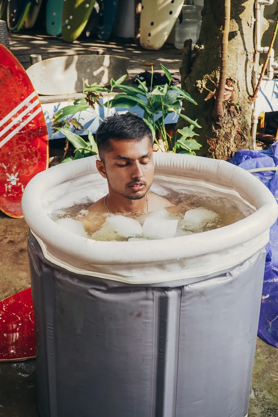 A guest in the ice bath in the yard after a session