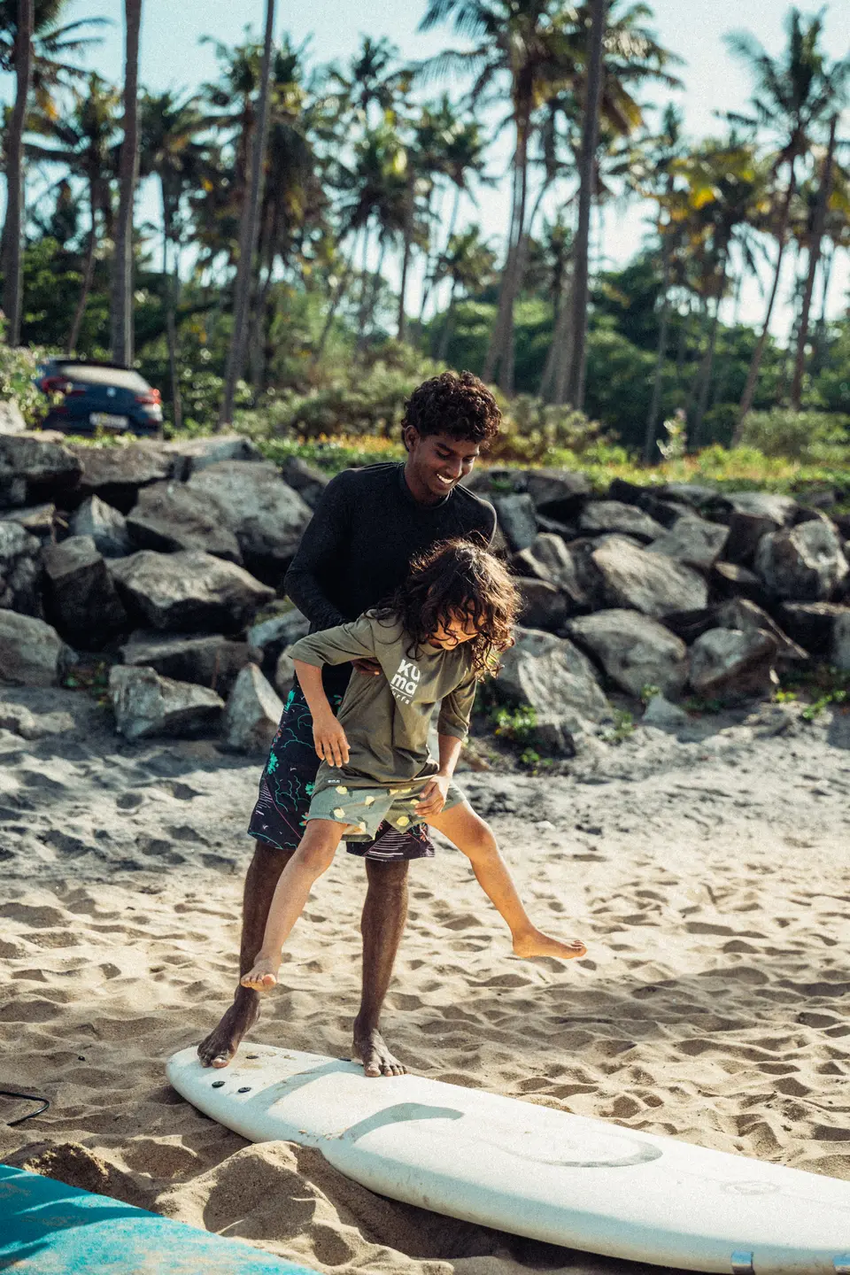 A kid getting a shove into a wave