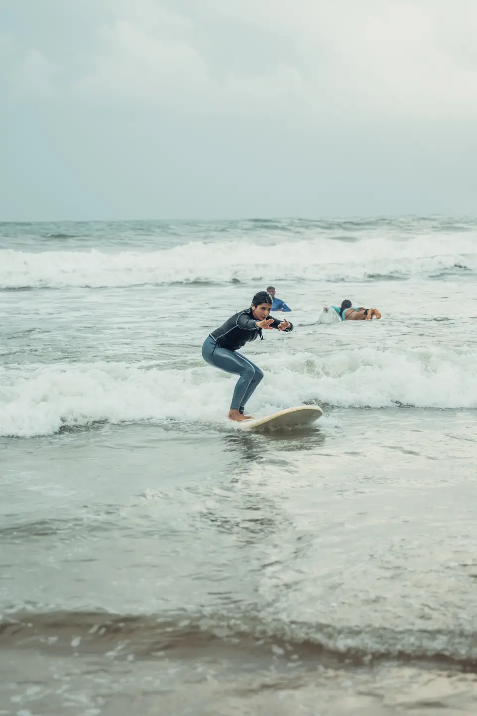 A student riding their first wave at Edava beach