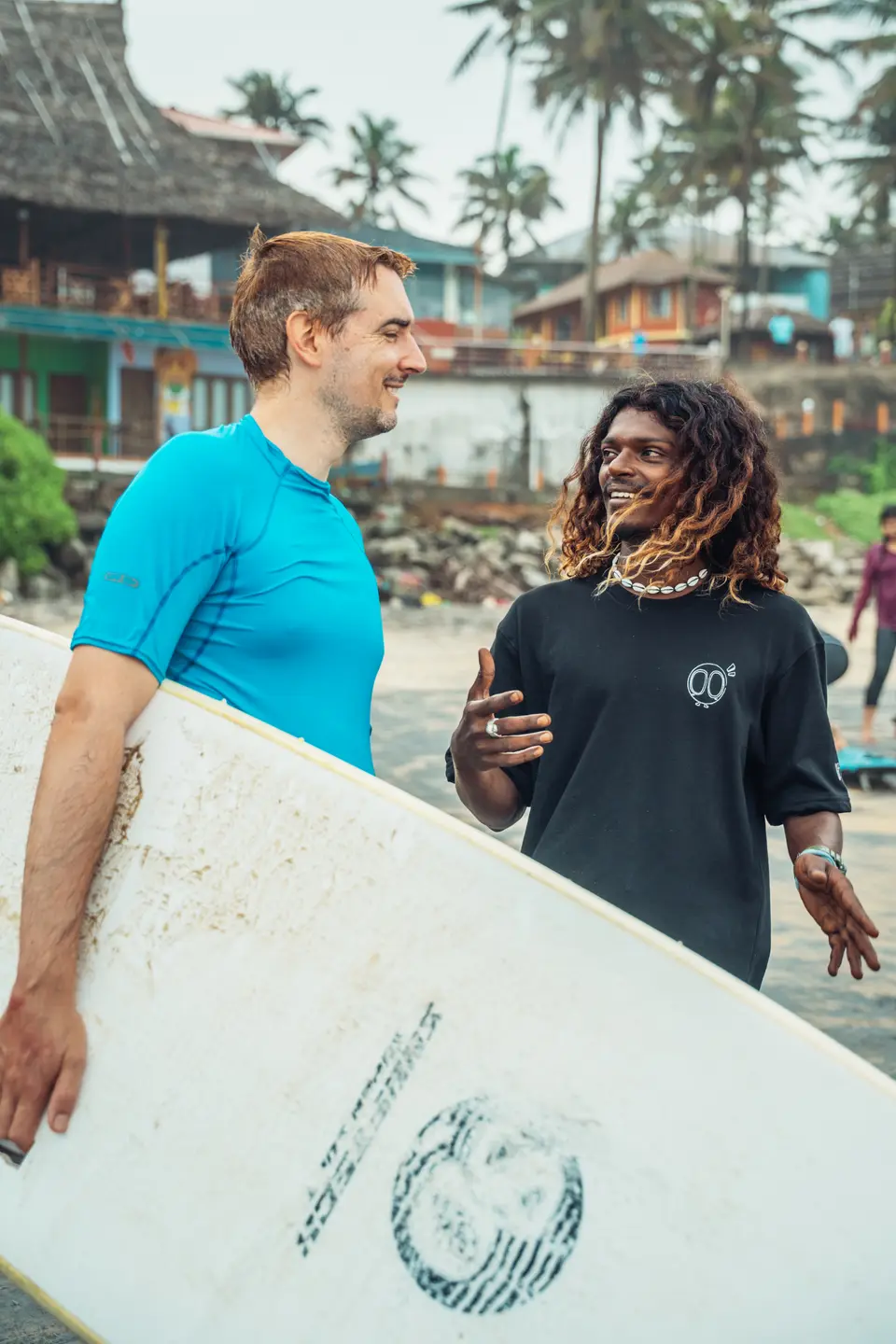 An instructor talking a guest through it, board under one arm