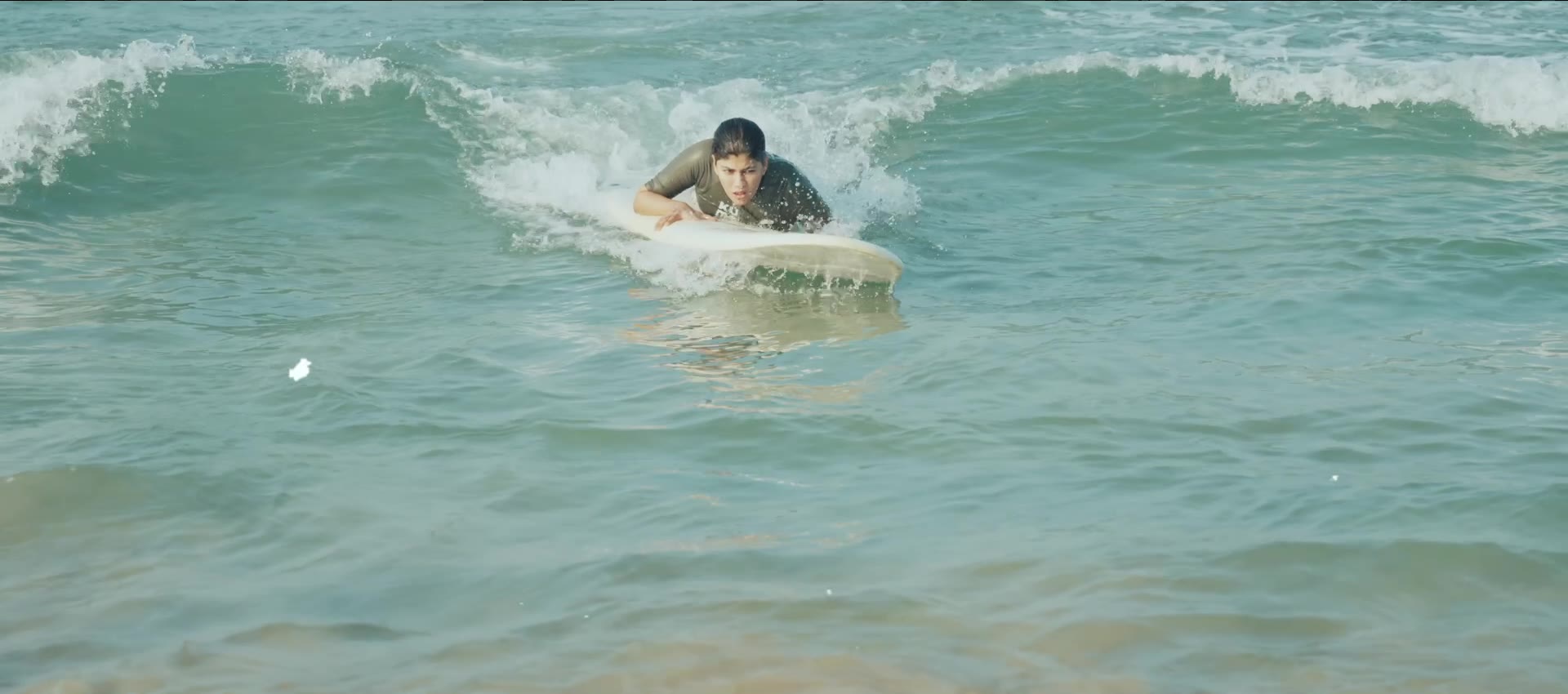 Still from the film: Beginners catching their first waves at Edava, Varkala